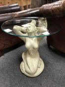 An ornate 'Mermaid' circular glass topped lamp table, diameter 61 cm.
