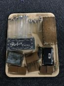 A tray containing seven glass bottles, two with silver tops, leather cased tools,