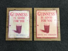 Two Guinness advertisements mounted on pine boards