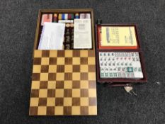 A cased Mahjong set together with a wooden games compendium