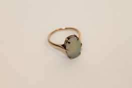 An opal ring, in a claw setting upon a plain gold shank,