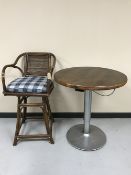 A poser bar table on metal base and a bamboo swivel bar chair