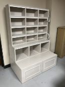 A bespoke painted MDF shelving unit fitted cupboards below and fitted LED lighting strips (two