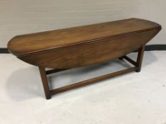 An oblong mahogany drop leaf coffee table