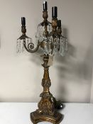 A contemporary gilt table lamp with glass drops
