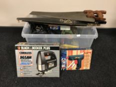 A plastic box containing assorted boxed power tool, including glue gun, drill,