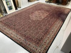 A large Persian design woollen carpet on blue ground a/f