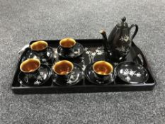 An Oriental lacquered coffee set on tray