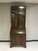 A mahogany bureau bookcase on bracket feet