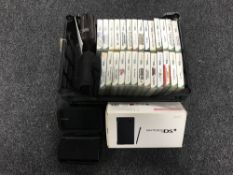 A basket containing three Nintendo DS with carry cases,