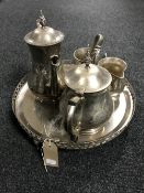 A four piece silver plated tea set on stand,