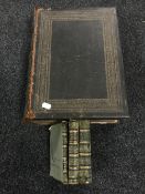 A leather bound family bible, together with three antiquarian volumes,