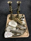 A tray containing a pair of brass candlesticks,