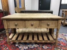 A reclaimed pine three drawer side table,