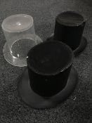 Three plastic top hats