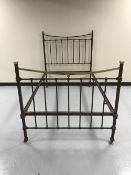 A painted cast iron and brass 4' bed frame