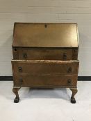 A mahogany writing bureau on claw and ball feet