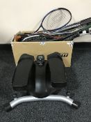 A box containing a collection of assorted tennis rackets and golf clubs,