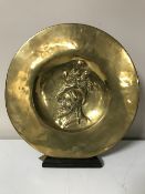 A Spanish brass plaque on a stand