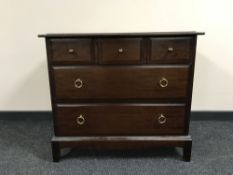 A Stag five drawer chest in a mahogany finish