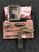 A part silver manicure set, together with a sterling silver photo frame,