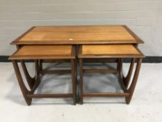 A nest of three teak G Plan tables