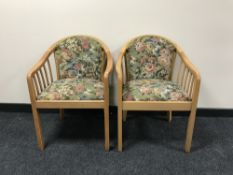 A pair of contemporary tub chairs upholstered in a floral fabric