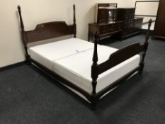 A Stag four foot six bed frame in a mahogany finish,