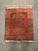 A fringed Afghan rug,