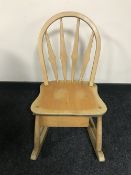 A children's Ercol rocking chair, fitted with a storage box beneath,