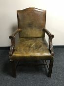 An early twentieth century Gainsborough style armchair upholstered in a leather button covering