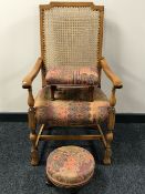 A bergere back armchair upholstered in a multi coloured fabric together with two footstools
