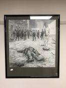 A framed pencil drawing depicting figures in a war zone, signed L.