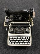 A cased Singer electric sewing machine,