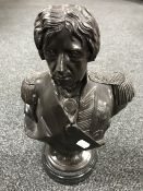 A patinated metal bust of Nelson on a marble plinth,