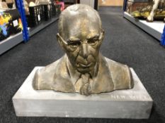 A plaster bust of a gentleman on stand, inscribed C.W.