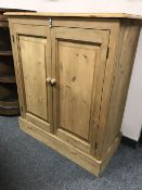 A pine double door cabinet,