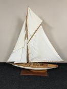 A wooden single masted pond yacht on stand