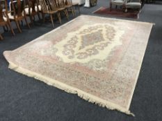 A large floral fringed woollen carpet on cream ground