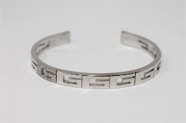 An 18ct gold diamond set bangle by Gucci, 28.