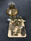 A tray containing a pair of brass candlesticks, a brass mantel clock, a brass model of a Spitfire,