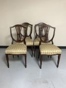 A set of four mahogany shield backed chairs