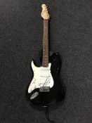 A Encore electric guitar with carry strap