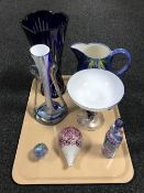 A tray containing a blue flash crystal flower vase, other coloured glassware, a pottery jug,