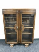 A twentieth century oak glazed door bookcase