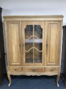 A twentieth century oak sideboard with glazed panel door