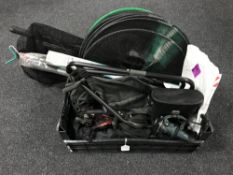 A basket containing assorted fishing equipment, landing nets, folding seat,