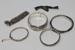 A collection of silver bangles and bracelets