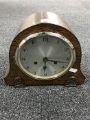 An oak cased mantel clock with silvered dial (with pendulum and key)