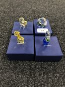 Four boxed Swarovski Crystal figures; giraffe, flower in pot,